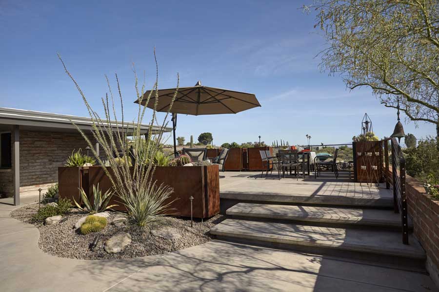 Landscaping design in Arizona with shaded patio, agave, and desert willow